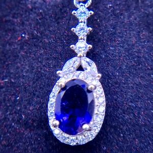 Solid silver dangling blue sapphire with white topaz